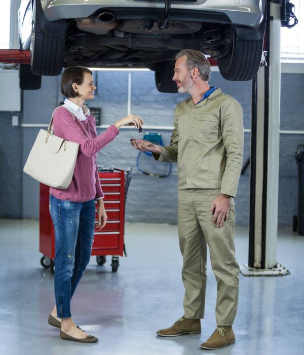 Mechanic inspecting a car during a pre-purchase inspection