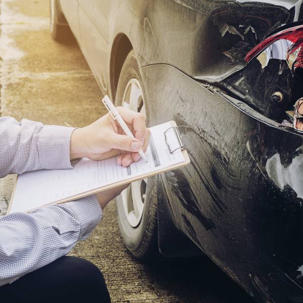 Person holding a Roadworthy Certificate after a vehicle inspection