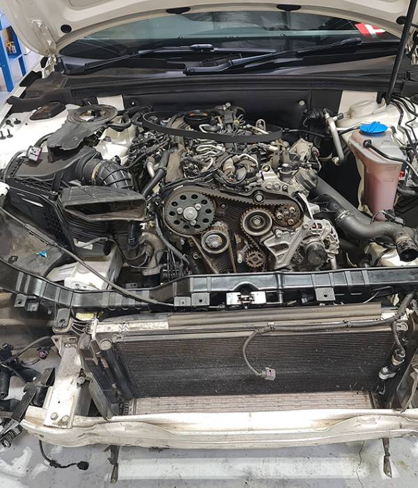 Engine top view showing ignition coils and components during timing chain replacement